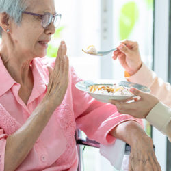 elderly woman refuses food
